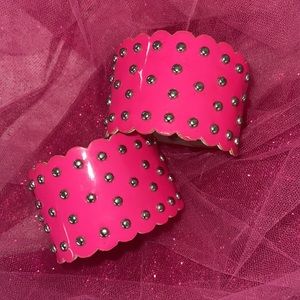 Studded pink cuffs.